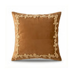 Brown pillow with decorative gold trim on a white background