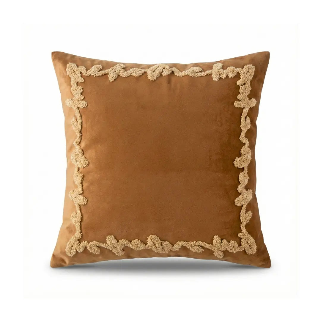 Brown pillow with decorative gold trim on a white background