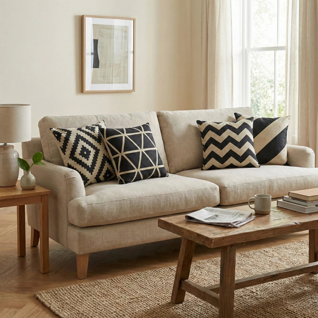 Beige sofa with decorative pillows in a living room setting
